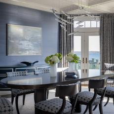 Formal Dining Room With Dark Blue Walls and Seating for Eight