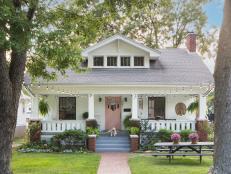 White Craftsman-Style Home With a Pink Door