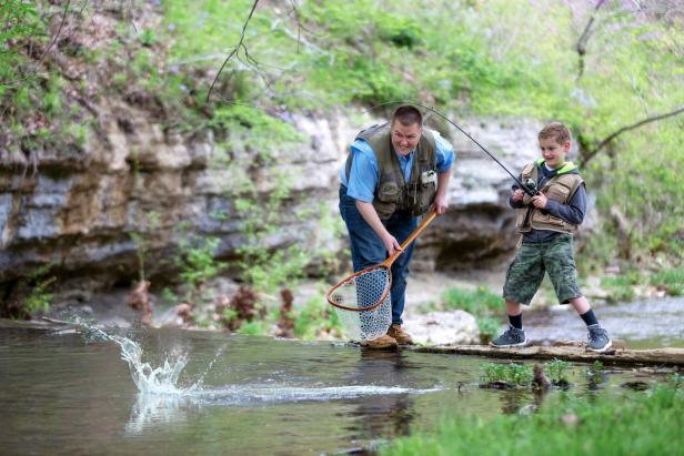A man and boy fishing in Dogwood Canyon Nature Park in Lampe, Missouri
