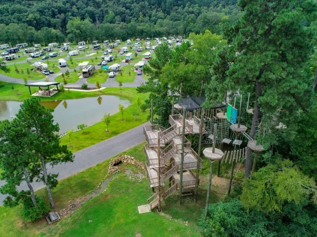 An aerial view of campers, a pond and a climbing tower at RVC Outdoor Destinations, Catherine's Landing, Hot Springs, Arkansas.