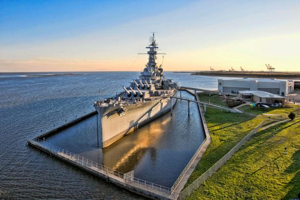 late afternoon aerial shot of the USS Alabama Battleship and park in Mobile, Alabama