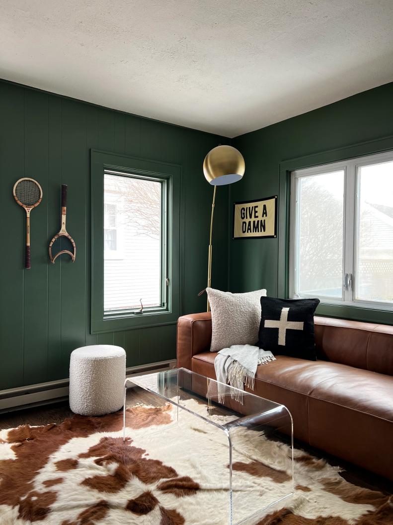 Green Den With Leather Sofa and Cowhide Rug