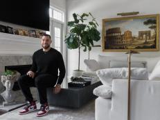 Man Sits on Marble Coffee Table in Classic Meets Modern Living Room