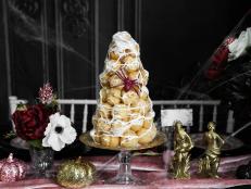 This tower of sweets may look complicated to make, but this easy recipe uses a shortcut with store-bought frozen profiteroles.