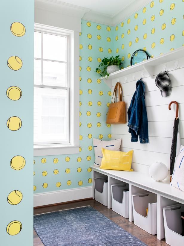 Tennis-Themed Mudroom With Wallpaper and a Storage Unit