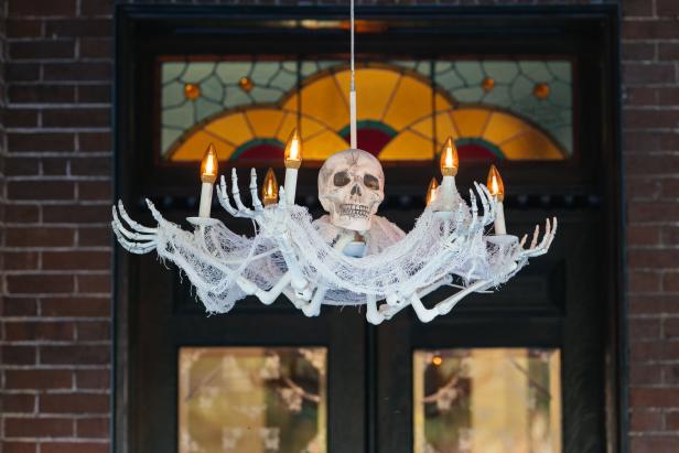 Chandelier made of hand bones and a skull.