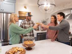As seen on Fixer to Fabulous, hosts Dave and Jenny Marrs have a glass of wine in the renovated kitchen with homeowners Sondra and Tom Puorro.