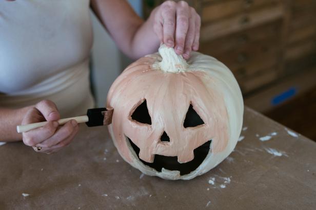 A plastic Halloween pumpkin goes from cheap to charming using an easy and  budget-friendly faux terracotta technique.