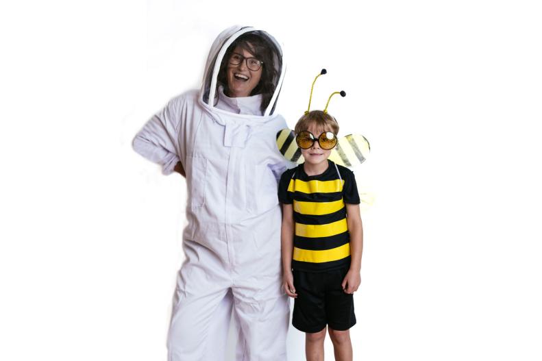 Woman dressed as a beekeeper with a child dressed as a bee