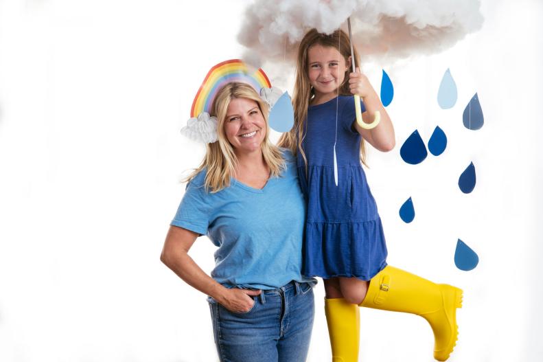 Woman dressed as a rainbow with child dressed as a rain cloud