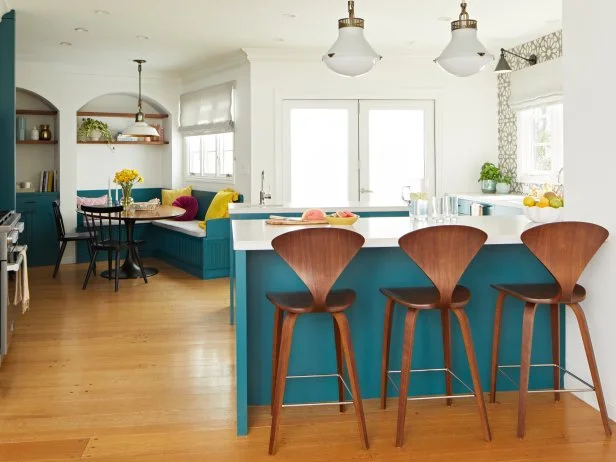 White Contemporary Kitchen With Walnut Stools and Teal Cabinets