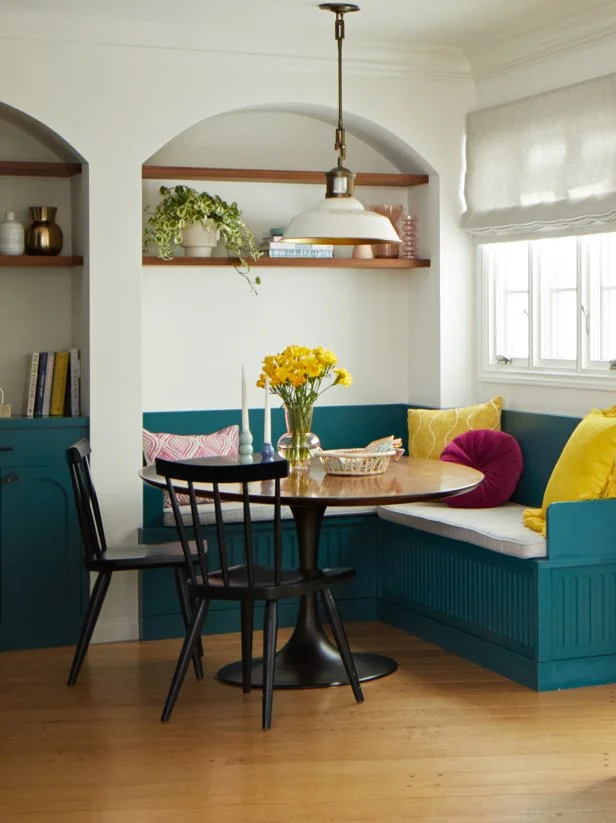 White and Teal Breakfast Nook With an Arched Wall and Banquette