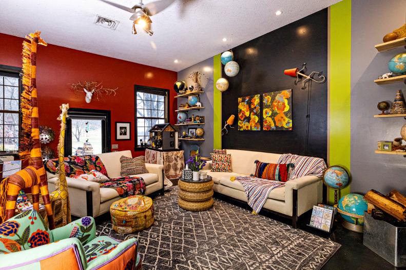 Large living room with raised floor, couches, and African decor. 