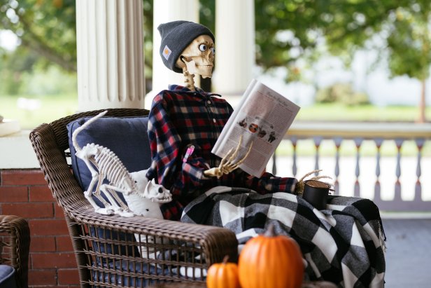 Skeleton reading a magazine and drinking coffee