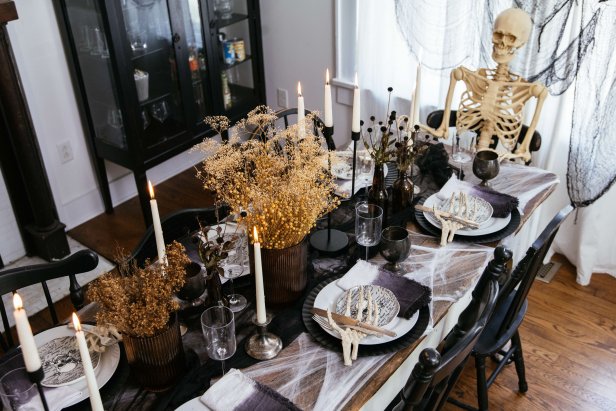 Skeleton sitting at a styled Halloween table