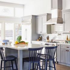 White Transitional Chef Kitchen With Blue Barstools