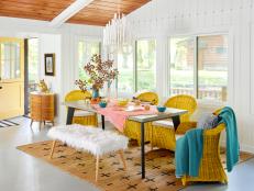 Eclectic Dining Area in an Updated Cabin With Yellow Chairs