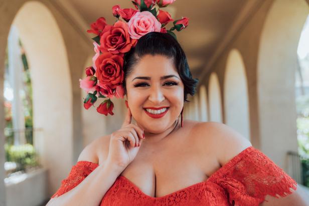 A photo of Nathaly Aguilera in a red rose flower crown.