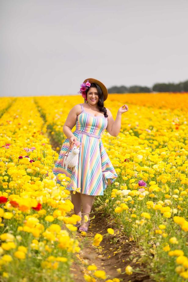 A photo of Nathaly Aguilera in a yellow flower field.