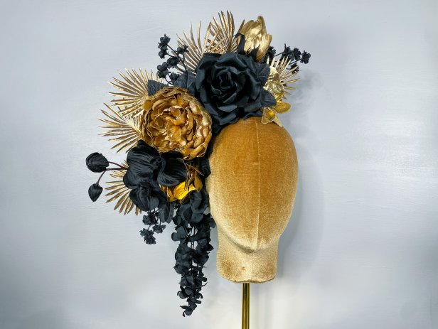 A photo of a gold and black flower headpiece by La Casa De Flores.