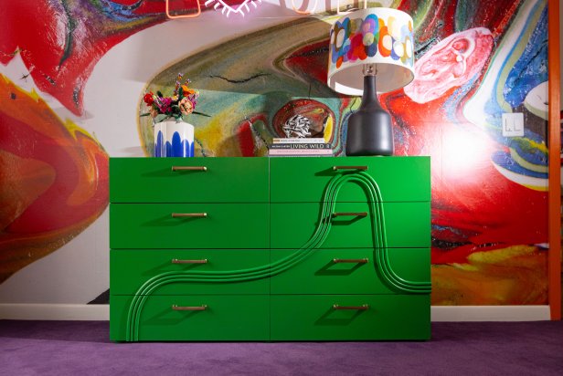 An ultra-saturated shade of paint like this gregarious green can hold its own in front of a bold wall mural, and the shadows the dresser's custom, 3D detailing throws contribute to its groovy character.