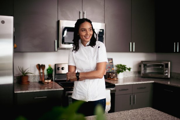 A photo of Chef Cris Ravarré smiling in her kitchen.