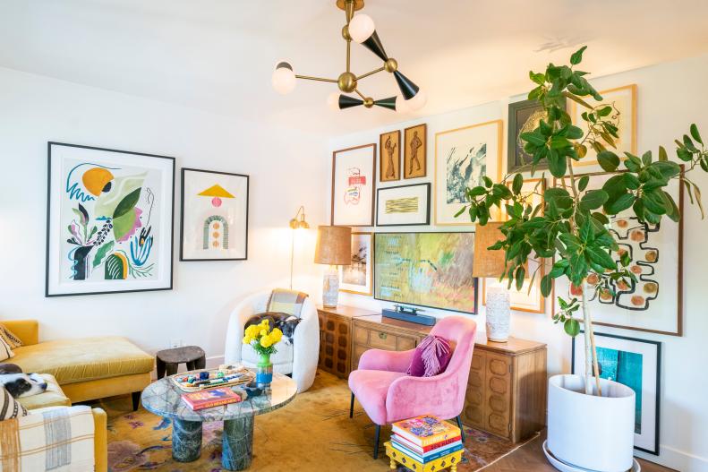 Eclectic, maximalist living room with a gallery wall and custom lights