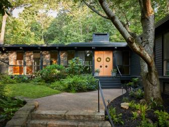 Midcentury-Style Dark Green Ranch House With a Peach Door