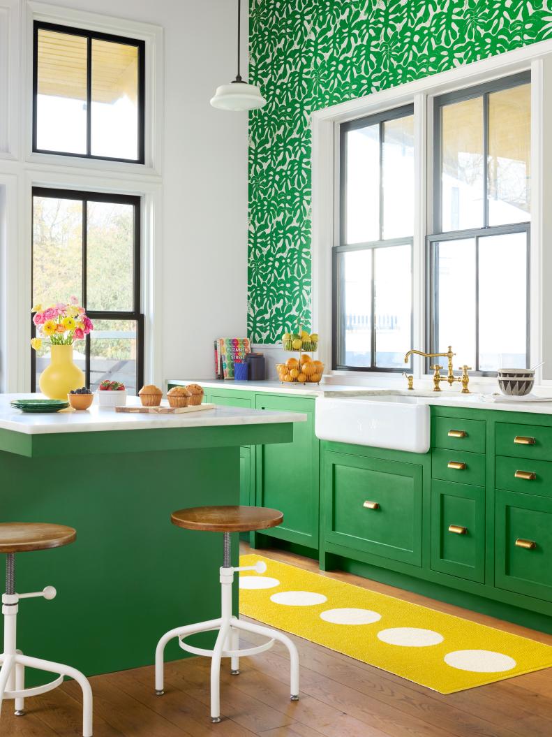 Green Kitchen With a Modern Yellow Runner and Wallpaper