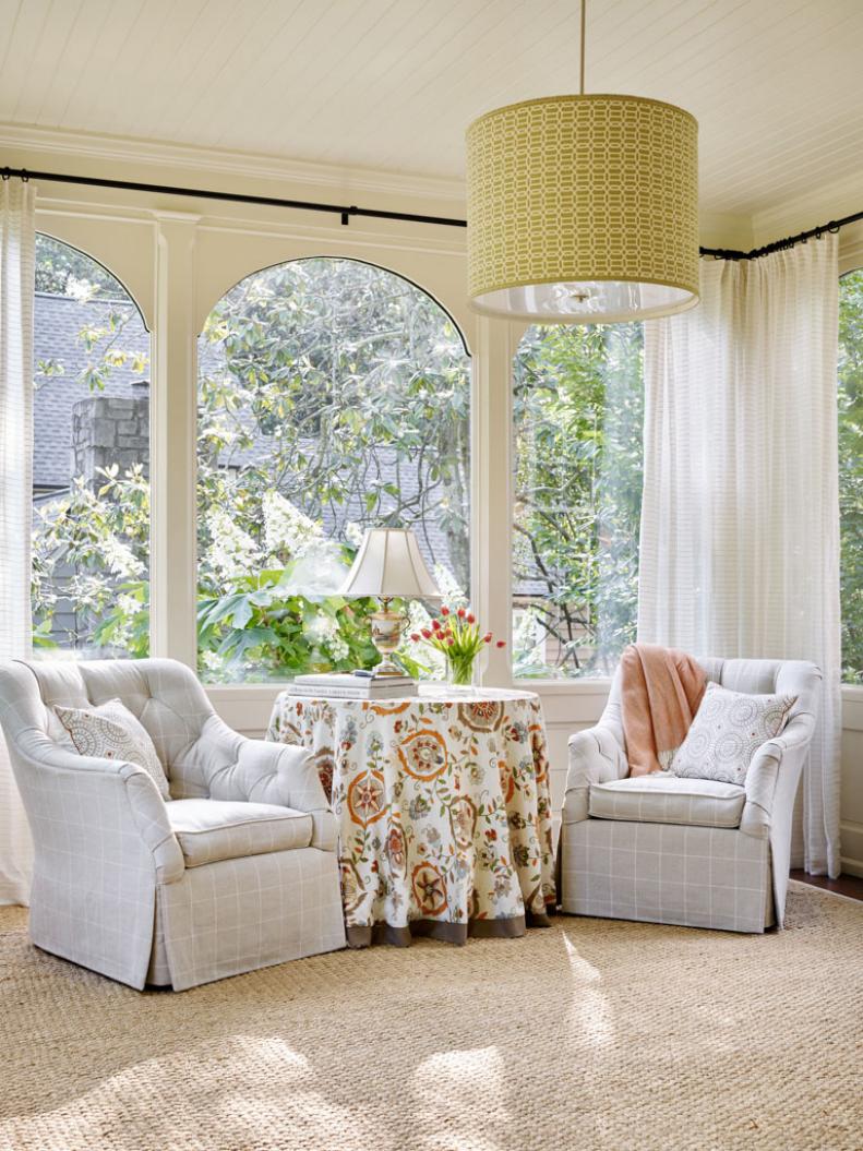 Though the beauty of a sunroom are the many windows that allow light to stream in, the ethereal white curtains shown here offer the opportunity to moderate too-bright sunshine when needed.