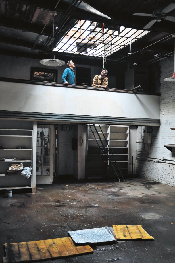 Two Men Stand on Second Floor of Home With Open Roof