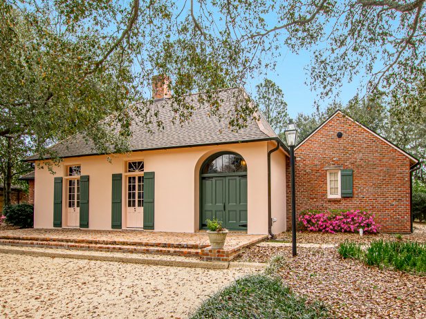 Pink House With Dark Green Shutters and Doors