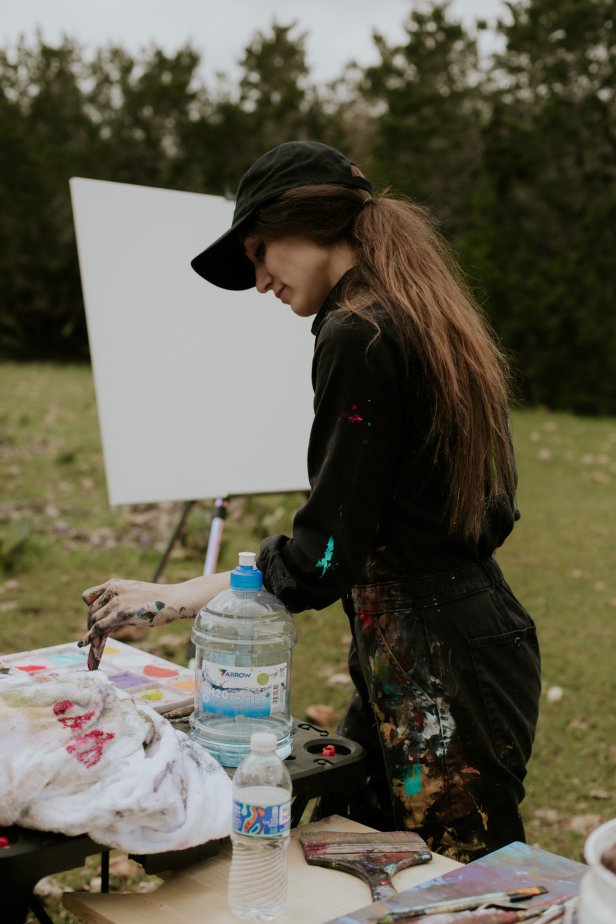 Artist Sarah Kraning mixes her paint outdoors.