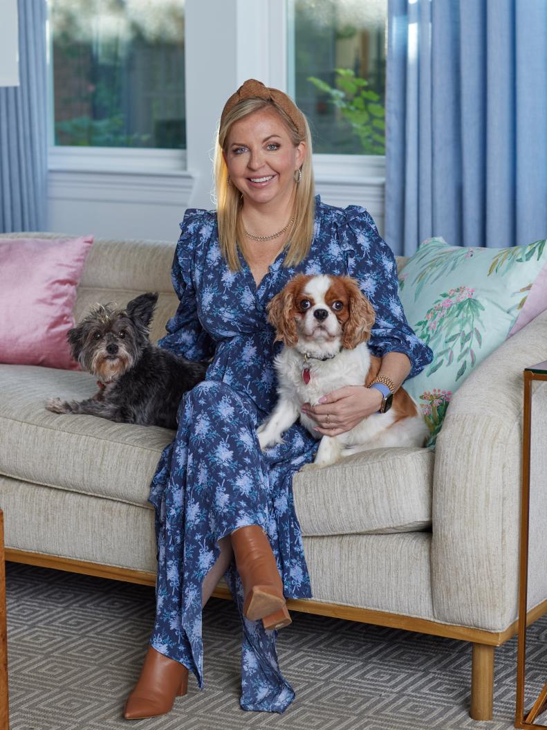 Woman and Two Small Dogs on a Sofa
