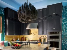 Blue and Teal Kitchen With Wallpaper and Black Cabinets