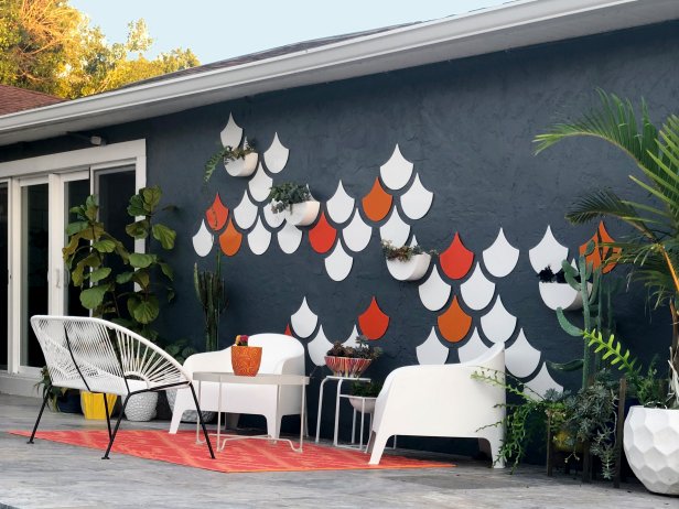 Navy Blue Exterior Wall With Fish Scale Art and Patio Furniture