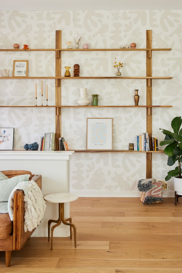 Open brown shelving with books, vases and other knick-knacks. 