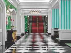 One of the hallmarks of Hollywood Regency is blending bold color with graphic black and white. Here, Dorothy Draper's hall and staircase leading to the casino at the Greenbrier resort builds anticipation.