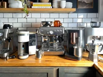 Several Espresso Machines on a Countertop