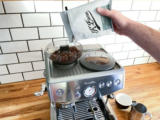 Pouring Coffee Into an Espresso Machine