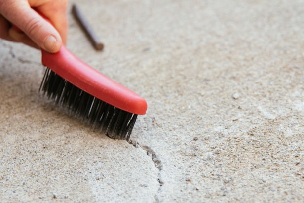 Use a wire bristle brush to scrub away any crumbles from inside the crack.