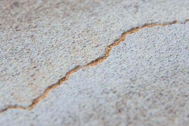 Crack in concrete filled with masonry sand until the crack is 1/4 inch deep.