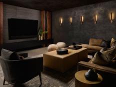 Atlanta interior designer Michael Habachy makes the mood as central as the media in this home theater whose dark walls and neutral color scheme creates a space conducive to the viewing experience.