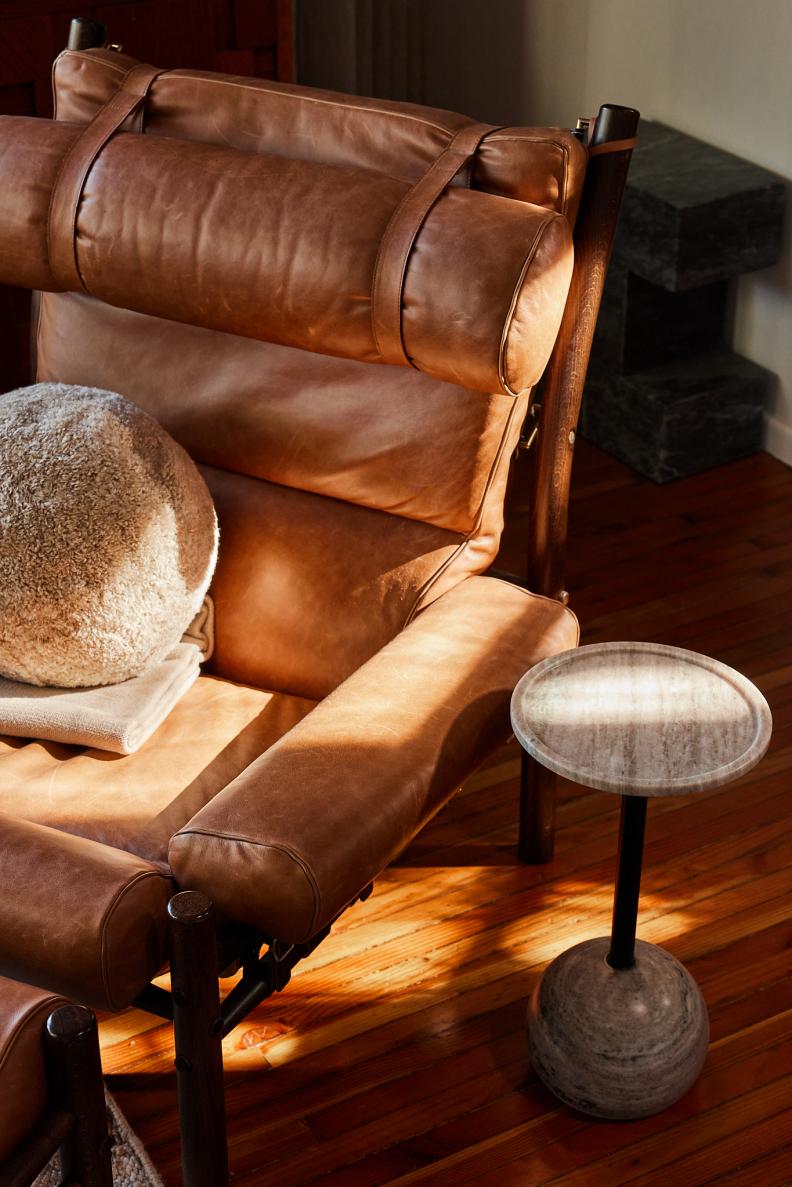 Leather Chair with Fuzzy Pillow and Blanket Sits in the Sun