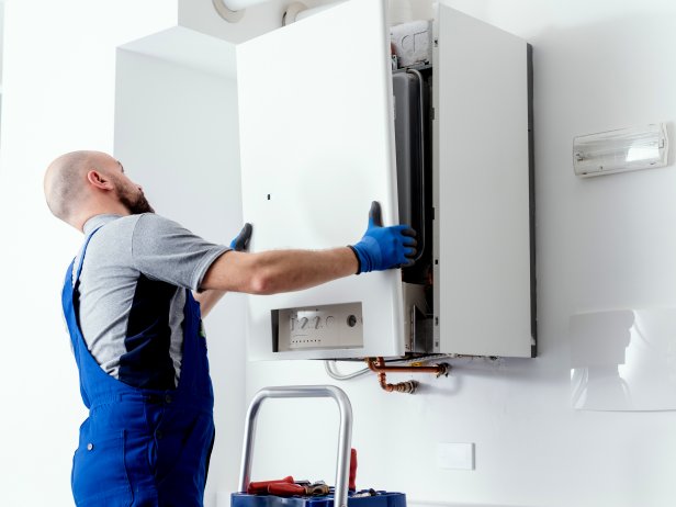 Professional engineer doing a boiler inspection at home