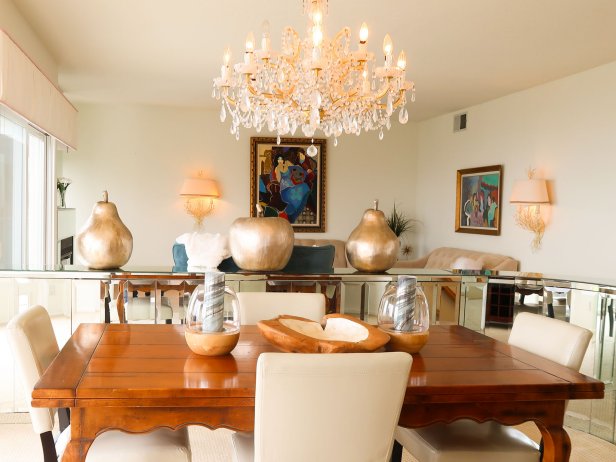 Amazing chandelier over the wood dinning table and carpet floors, the living area follows, hero house