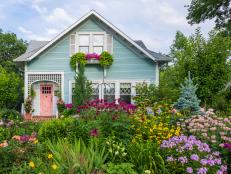 Blue House With a Pink Door and a Stunning Garden