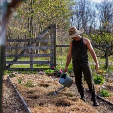 Brian Brigantti Waters a Flowerbed At His Tennessee Farm