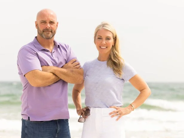 Judges Sarah and Bryan Baeumler pose on the beach, as seen on Battle on the Beach, Season 3.