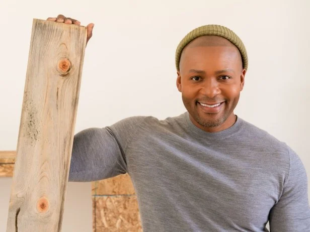 Designer Michel Smith Boyd poses for a potrait with locally sourced Beetle Kill wood for the living room ceiling, as seen on Rock the Block, Season 4.